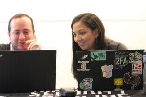 two people looking at a laptop.